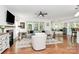 Bright living room with hardwood floors, fireplace, ceiling fan, and lots of natural light from surrounding windows at 9930 Karras Commons Way, Matthews, NC 28105