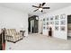 A cozy loft area with neutral carpeting, ceiling fan, and plenty of natural light at 9930 Karras Commons Way, Matthews, NC 28105
