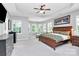 Spacious main bedroom with tray ceiling, ceiling fan, and a wall of windows at 9930 Karras Commons Way, Matthews, NC 28105
