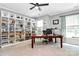 Spacious home office with built-in shelves, a large desk, and natural light at 9930 Karras Commons Way, Matthews, NC 28105