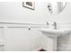 Modern powder room with white walls and a sleek pedestal sink at 9930 Karras Commons Way, Matthews, NC 28105