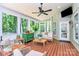 Relaxing sunroom with wood floors, ceiling fan, and lots of windows to enjoy the outdoors at 9930 Karras Commons Way, Matthews, NC 28105