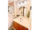 Bright bathroom with oak vanity, crystal lighting fixture, and octagon mirror at 101 Keswick Ln, Mooresville, NC 28117