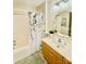 Bright bathroom with floral shower curtain and oak vanity with octagon mirror at 101 Keswick Ln, Mooresville, NC 28117