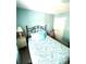 Bright bedroom with light blue walls, a comfortable bed, and a view of the window at 101 Keswick Ln, Mooresville, NC 28117