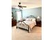 A bedroom with a metal bed frame, ceiling fan, and light blue walls at 101 Keswick Ln, Mooresville, NC 28117