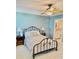 A bedroom with a metal bed frame, ceiling fan, and light blue walls at 101 Keswick Ln, Mooresville, NC 28117