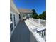 Expansive, sun-drenched deck with white railings, patio furniture and view of mature trees at 101 Keswick Ln, Mooresville, NC 28117
