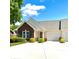 Inviting home with brick facade, a cozy front porch with seating, and a well-maintained lawn at 101 Keswick Ln, Mooresville, NC 28117