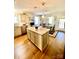 Bright eat-in kitchen featuring center island with granite countertop and hardwood flooring at 101 Keswick Ln, Mooresville, NC 28117