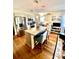 Open kitchen with stainless steel appliances, granite island, and hardwood floors at 101 Keswick Ln, Mooresville, NC 28117