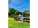 Scenic view of the community pond with a water fountain feature surrounded by lush trees, from the fishing pier at 101 Keswick Ln, Mooresville, NC 28117