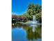 Scenic view of the community pond with a water fountain feature surrounded by lush trees and pink crepe myrtle at 101 Keswick Ln, Mooresville, NC 28117