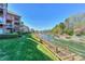 Charming balcony view from condo with lush lawn, wooden walkway, and scenic waterfront vista at 104 Pier 33 Dr # 312, Mooresville, NC 28117