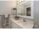 Bright bathroom featuring white cabinetry, framed mirror and decorative accents at 104 Pier 33 Dr # 312, Mooresville, NC 28117