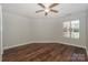 A naturally illuminated primary bedroom with a ceiling fan and wood-look floors at 104 Pier 33 Dr # 312, Mooresville, NC 28117