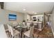 Elegant dining room with modern table, connecting the kitchen and living spaces at 104 Pier 33 Dr # 312, Mooresville, NC 28117