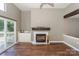 Living room featuring a fireplace, wet bar, and access to the balcony at 104 Pier 33 Dr # 312, Mooresville, NC 28117