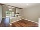 Open living area with a balcony, fireplace, ceiling fan, and wood flooring at 104 Pier 33 Dr # 312, Mooresville, NC 28117