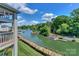 Picturesque waterfront view with docks and lush greenery under a sunny sky at 104 Pier 33 Dr # 312, Mooresville, NC 28117