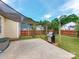 The backyard has a grill, patio, shade, and green grass at 10408 Milstead Ct, Charlotte, NC 28215