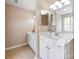 This bathroom features a double sink, cabinets, and tiled floor at 10408 Milstead Ct, Charlotte, NC 28215
