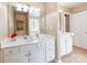 This bathroom features a double sink, cabinets, mirror, and tiled floors at 10408 Milstead Ct, Charlotte, NC 28215