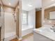 This bathroom features a shower, tub, and sink with a white cabinet at 10408 Milstead Ct, Charlotte, NC 28215