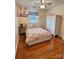 Bright bedroom with hardwood floors, ceiling fan, and ample storage space at 10408 Milstead Ct, Charlotte, NC 28215
