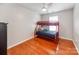 This bedroom has hardwood floors, a bunk bed, and a ceiling fan at 10408 Milstead Ct, Charlotte, NC 28215