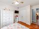 This bedroom has hardwood floors, a bed, a wardrobe, and ceiling fan at 10408 Milstead Ct, Charlotte, NC 28215