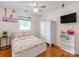 This bedroom has hardwood floors, a bed, and a wardrobe with drawers at 10408 Milstead Ct, Charlotte, NC 28215