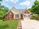 Inviting single-Gathering home with a brick and vinyl facade, red shutters, and a lush green lawn at 10408 Milstead Ct, Charlotte, NC 28215