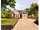 Charming single-Gathering home showcasing a well-maintained front yard, a brick facade, and a private driveway at 10408 Milstead Ct, Charlotte, NC 28215