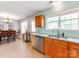 Bright kitchen with stainless steel appliances, a double sink, and a view to the dining area at 10408 Milstead Ct, Charlotte, NC 28215