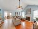 Spacious living room with vaulted ceilings, a cozy fireplace, and an open layout at 10408 Milstead Ct, Charlotte, NC 28215