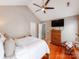 Cozy main bedroom featuring hardwood floors, a ceiling fan, and a large dresser with a mirror at 10408 Milstead Ct, Charlotte, NC 28215
