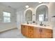 Well-lit bathroom with double vanity, stylish mirrors, and modern fixtures and natural light at 117 Mills Ln, Fort Mill, SC 29708