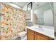 Colorful bathroom featuring a vibrant shower curtain, classic toilet, and neutral fixtures at 117 Mills Ln, Fort Mill, SC 29708