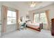 Bright bedroom featuring large windows, a vanity desk, and a cozy bed with pink accents at 117 Mills Ln, Fort Mill, SC 29708