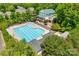 Large community pool with many lounge chairs and shade umbrellas, with mature tree border at 117 Mills Ln, Fort Mill, SC 29708