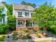 Charming two-story home featuring a welcoming front porch with brick stairs and landscaped yard at 117 Mills Ln, Fort Mill, SC 29708