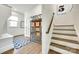 Bright hallway featuring hardwood floors, staircase, and built-in display cabinet with decorative baskets at 117 Mills Ln, Fort Mill, SC 29708