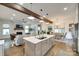 Open kitchen and living area featuring a large island, hardwood floors, and a fireplace at 117 Mills Ln, Fort Mill, SC 29708