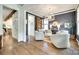 Stylish living room featuring hardwood floors, modern lighting, and neutral decor at 117 Mills Ln, Fort Mill, SC 29708