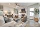 Spacious living room with a whitewashed brick fireplace, ceiling fan, and plush seating at 117 Mills Ln, Fort Mill, SC 29708