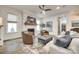 Inviting living room showcasing a brick fireplace, ceiling fan, and comfortable seating at 117 Mills Ln, Fort Mill, SC 29708