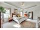 Bright primary bedroom featuring a tray ceiling, accent rug, and ample natural light at 117 Mills Ln, Fort Mill, SC 29708