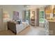 Comfortable bedroom with daybed, bookshelf and windows offering serene outdoor views at 12028 Royal Lytham Ct, Charlotte, NC 28277
