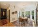 Bright dining room with large windows, hardwood floors, and elegant chandelier lighting at 12028 Royal Lytham Ct, Charlotte, NC 28277
